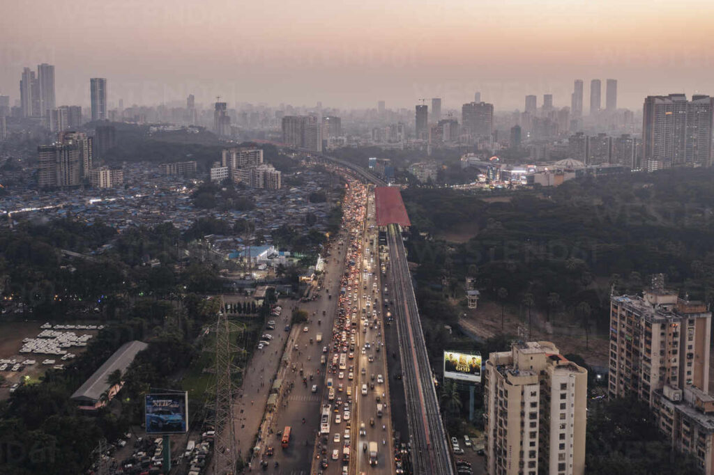 aerial view of busy, crowded mumbai city skyline at sunset with dense skyscrapers and modern infrastructure, mumbai metropolitan region, india.